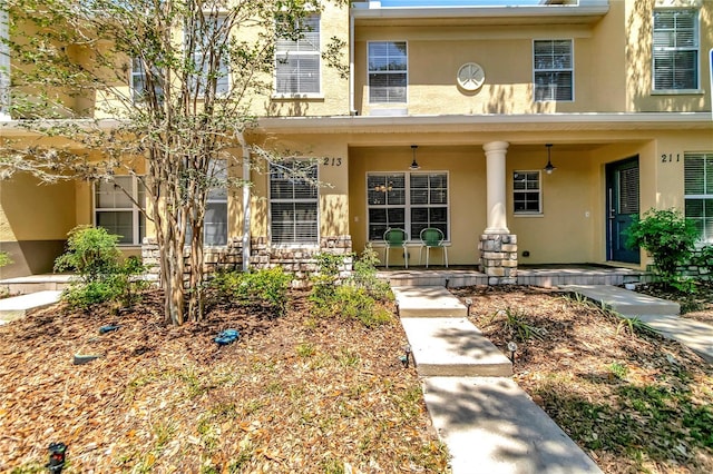 213 Draw Bridge Ln, Valrico, FL 33594 - view of front of house featuring stucco siding and a porch