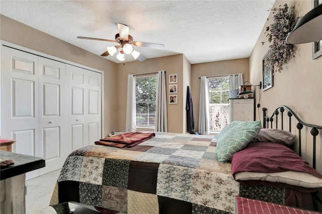 213 Draw Bridge Ln, Valrico, FL 33594 - carpeted bedroom featuring a closet, multiple windows, a ceiling fan, and a textured ceiling