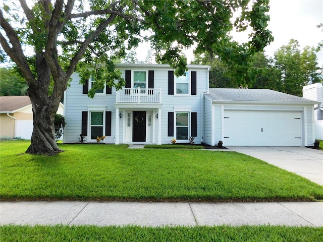 15916 Marshfield Dr, Tampa, FL 33624 - colonial-style house featuring a balcony, driveway, an attached garage, and a front lawn