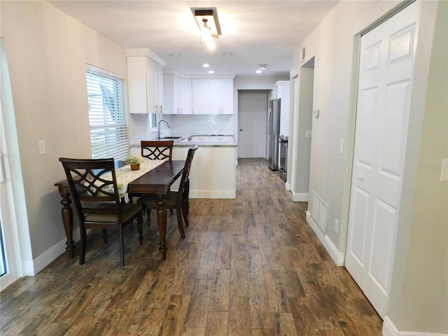 15916 Marshfield Dr, Tampa, FL 33624 - dining space featuring dark wood-style flooring and baseboards
