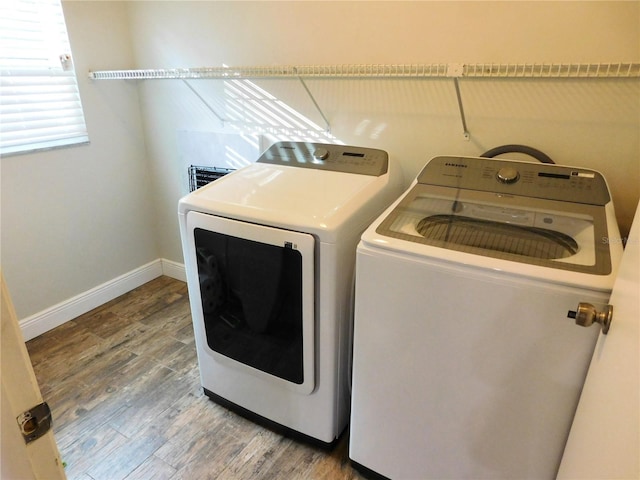 15916 Marshfield Dr, Tampa, FL 33624 - washroom featuring washer and clothes dryer and wood finished floors