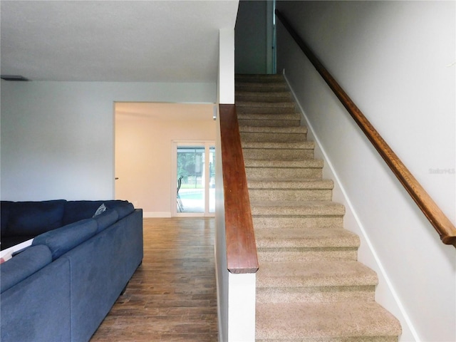 15916 Marshfield Dr, Tampa, FL 33624 - stairs featuring wood finished floors and baseboards