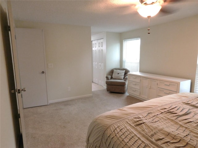 15916 Marshfield Dr, Tampa, FL 33624 - bedroom featuring light colored carpet, a textured ceiling, a closet, and ceiling fan