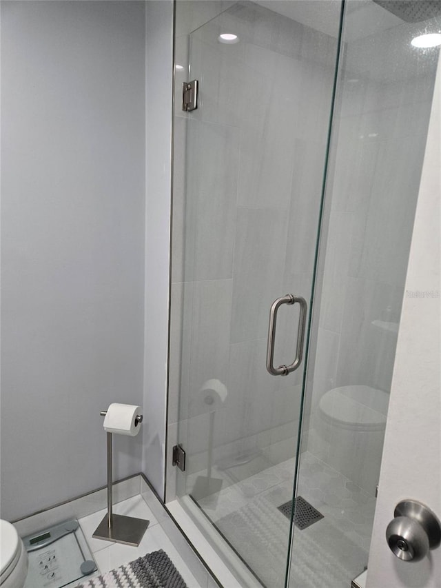 400 Island Way Unit 1606, Clearwater Beach, FL 33767 - bathroom featuring toilet, a shower stall, and tile patterned floors