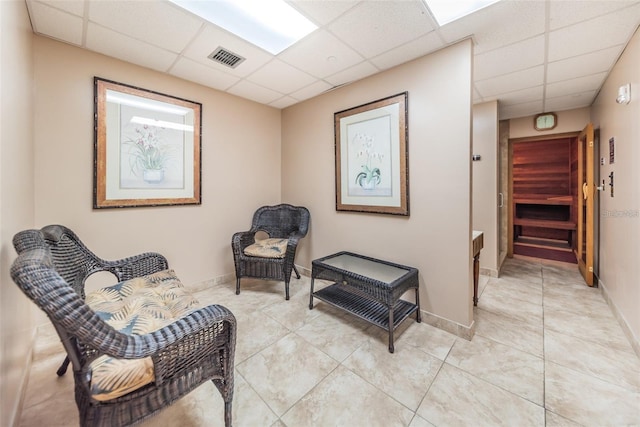 400 Island Way Unit 1606, Clearwater Beach, FL 33767 - living area with a drop ceiling, light tile patterned floors, and baseboards