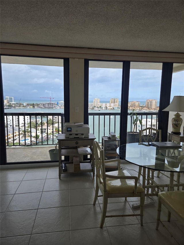 400 Island Way Unit 1606, Clearwater Beach, FL 33767 - tiled dining room featuring healthy amount of natural light, a view of city, a water view, and a textured ceiling