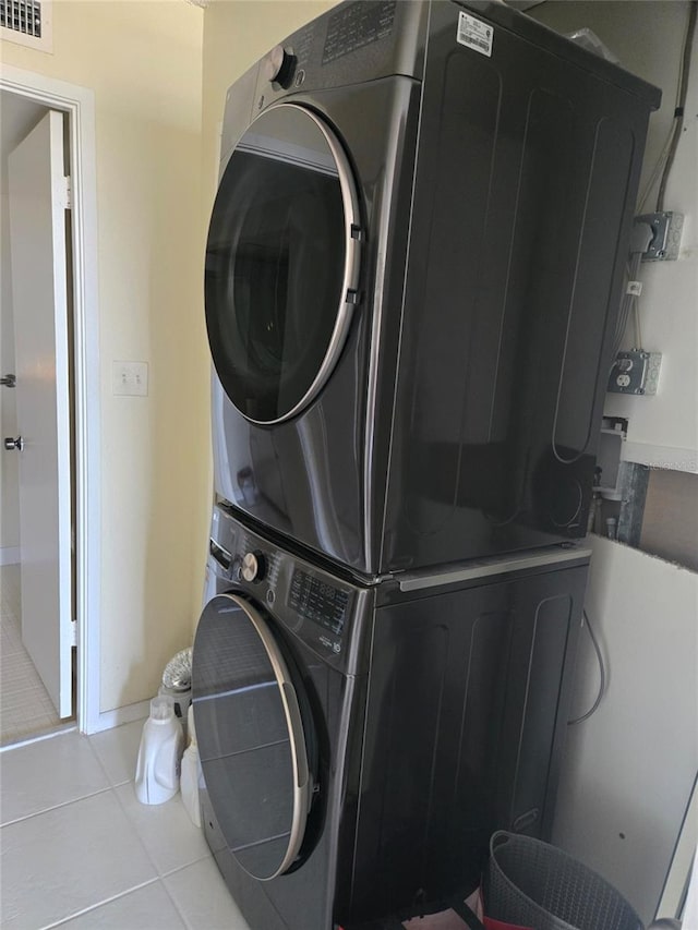 400 Island Way Unit 1606, Clearwater Beach, FL 33767 - laundry room featuring estacked washer and dryer and tile patterned flooring