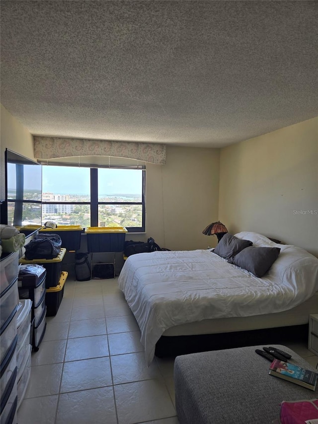 400 Island Way Unit 1606, Clearwater Beach, FL 33767 - bedroom featuring a textured ceiling and light tile patterned flooring