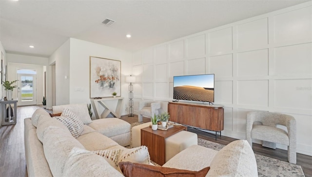 7747 Wheat Stone Dr, Zephyrhills, FL 33540 - living room featuring a decorative wall, wood finished floors, and recessed lighting