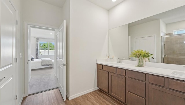 7747 Wheat Stone Dr, Zephyrhills, FL 33540 - full bath featuring wood finished floors, double vanity, a stall shower, and ensuite bathroom