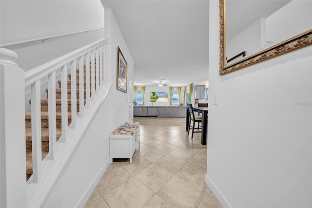 3216 Bryant Park Dr, New Port Richey, FL 34655 - corridor with light tile patterned floors, stairway, and baseboards