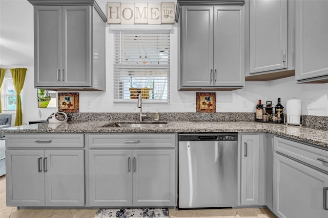 3216 Bryant Park Dr, New Port Richey, FL 34655 - kitchen featuring stainless steel dishwasher, a sink, gray cabinets, and light stone countertops