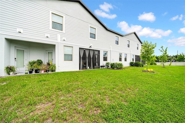 3216 Bryant Park Dr, New Port Richey, FL 34655 - rear view of house with a lawn and stucco siding