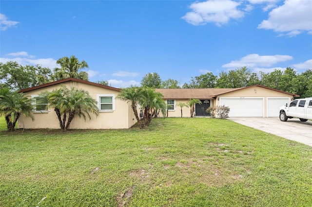 9220 Mcintosh Rd, Dover, FL 33527 - view of front of home featuring concrete driveway, an attached garage, stucco siding, and a front lawn