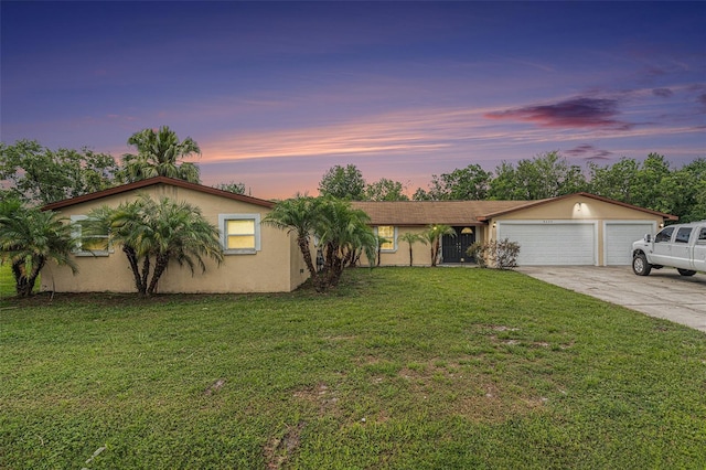 9220 Mcintosh Rd, Dover, FL 33527 - view of front of house featuring driveway, stucco siding, a front lawn, and a garage