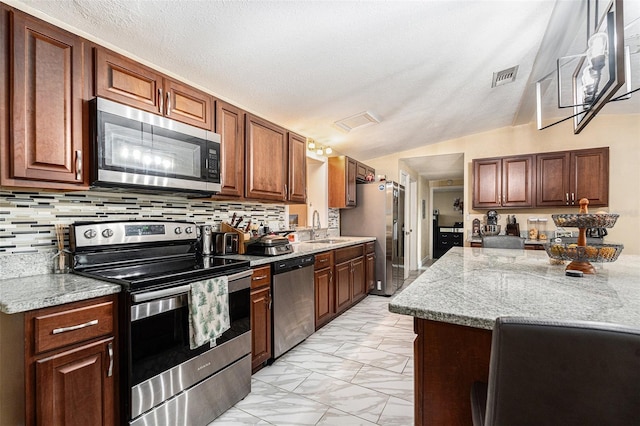 9220 Mcintosh Rd, Dover, FL 33527 - kitchen featuring appliances with stainless steel finishes, light marble finish floors, tasteful backsplash, and light stone counters