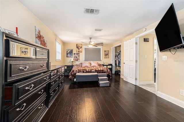 9220 Mcintosh Rd, Dover, FL 33527 - bedroom with wood finished floors, a ceiling fan, and a walk in closet