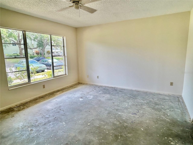 2391 Sumatran Way Unit 37, Clearwater, FL 33763 - unfurnished room with a ceiling fan, a textured ceiling, and baseboards