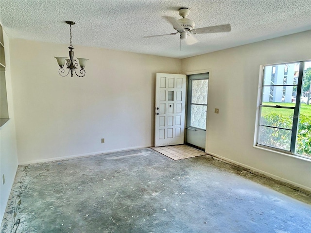2391 Sumatran Way Unit 37, Clearwater, FL 33763 - foyer entrance featuring plenty of natural light, a chandelier, unfinished concrete flooring, and a textured ceiling