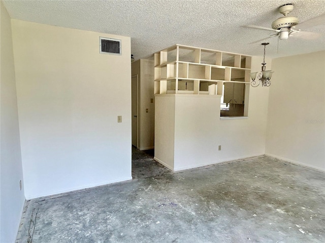 2391 Sumatran Way Unit 37, Clearwater, FL 33763 - spare room with concrete floors, a ceiling fan, a textured ceiling, and baseboards