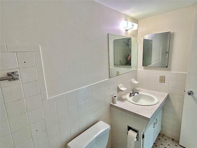 2391 Sumatran Way Unit 37, Clearwater, FL 33763 - half bathroom with tile walls, vanity, toilet, and a wainscoted wall