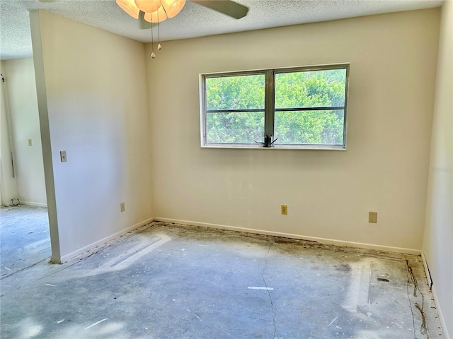 2391 Sumatran Way Unit 37, Clearwater, FL 33763 - empty room with a ceiling fan, a textured ceiling, and baseboards