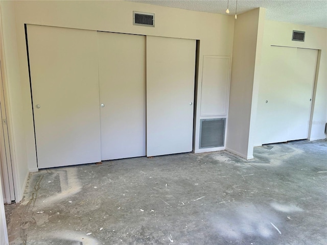 2391 Sumatran Way Unit 37, Clearwater, FL 33763 - unfurnished bedroom featuring a closet and a textured ceiling