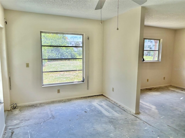 2391 Sumatran Way Unit 37, Clearwater, FL 33763 - spare room featuring a textured ceiling, ceiling fan, and baseboards