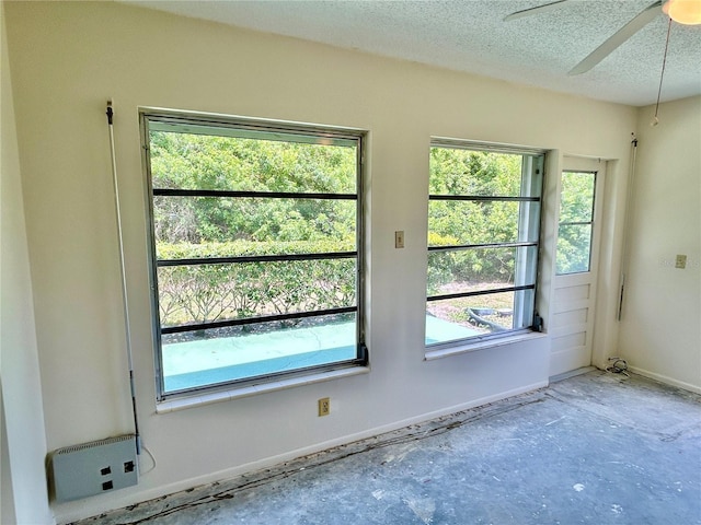 2391 Sumatran Way Unit 37, Clearwater, FL 33763 - unfurnished room featuring baseboards, a textured ceiling, and ceiling fan