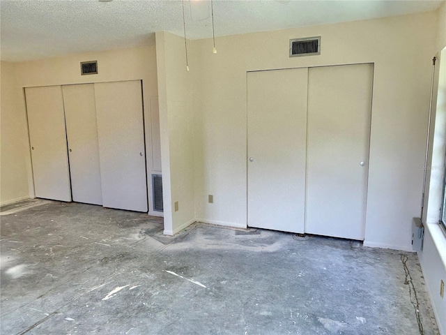 2391 Sumatran Way Unit 37, Clearwater, FL 33763 - unfurnished bedroom with a textured ceiling