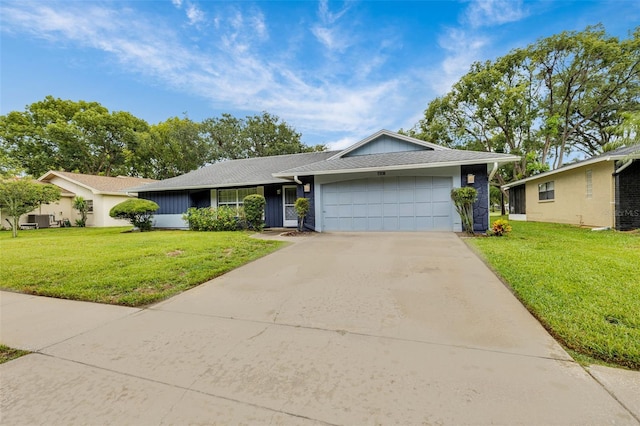 7708 Fairlawn Dr, Hudson, FL 34667 - single story home with a garage, concrete driveway, a front lawn, and roof with shingles