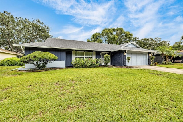 7708 Fairlawn Dr, Hudson, FL 34667 - view of front of home featuring a garage, driveway, and a front lawn