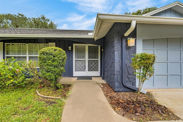 7708 Fairlawn Dr, Hudson, FL 34667 - doorway to property with board and batten siding and a shingled roof