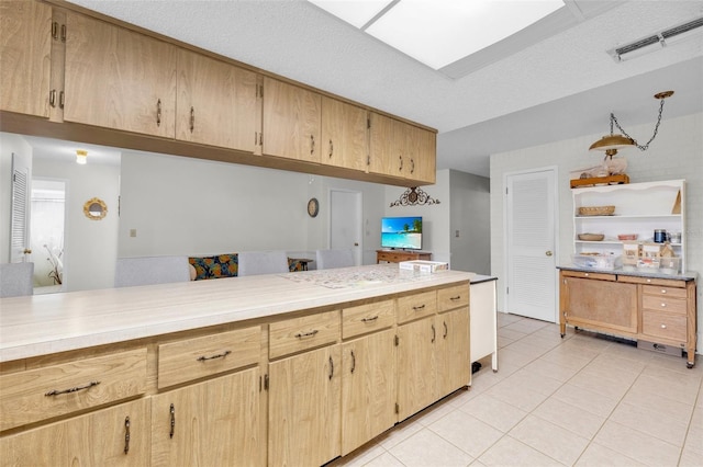 7708 Fairlawn Dr, Hudson, FL 34667 - kitchen with light tile patterned floors, light countertops, light brown cabinetry, and open shelves