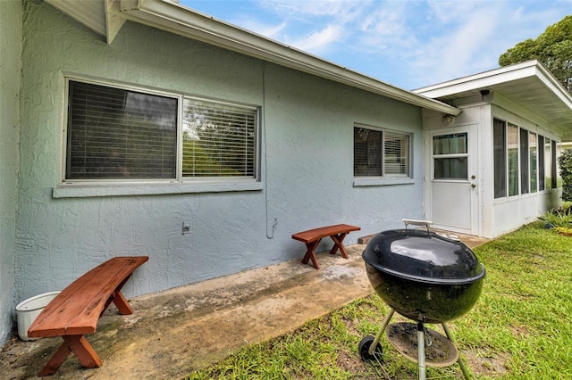 7708 Fairlawn Dr, Hudson, FL 34667 - view of property exterior with stucco siding, a sunroom, and a lawn