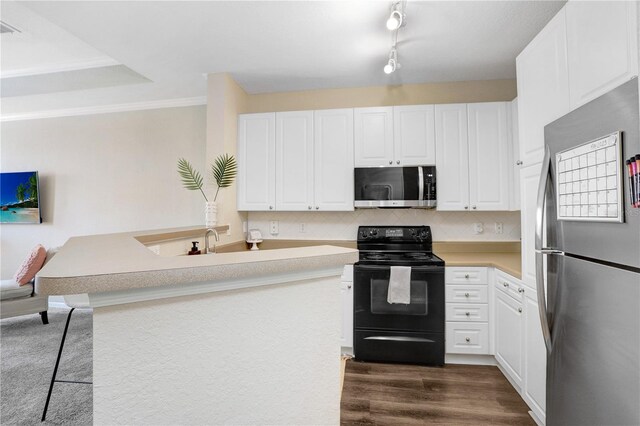 4221 W Spruce St Unit 1429, Tampa, FL 33607 - kitchen featuring stainless steel appliances, white cabinets, backsplash, and light countertops