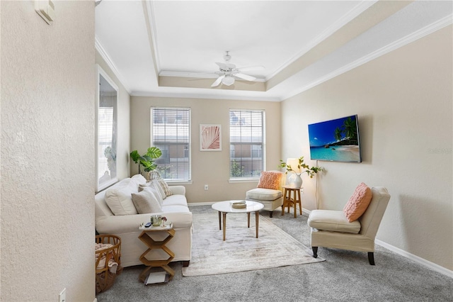 4221 W Spruce St Unit 1429, Tampa, FL 33607 - carpeted living area featuring ornamental molding, a raised ceiling, a textured wall, ceiling fan, and baseboards