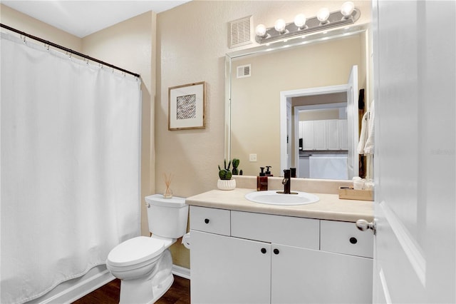 4221 W Spruce St Unit 1429, Tampa, FL 33607 - bathroom with toilet, vanity, and wood finished floors