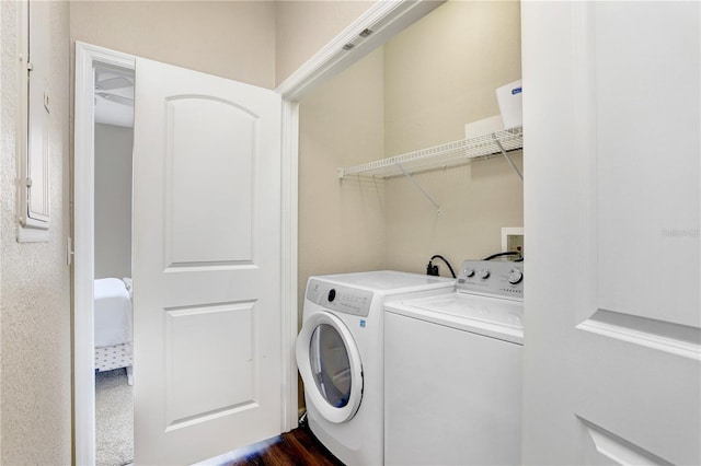 4221 W Spruce St Unit 1429, Tampa, FL 33607 - washroom featuring washing machine and dryer and dark wood-style flooring
