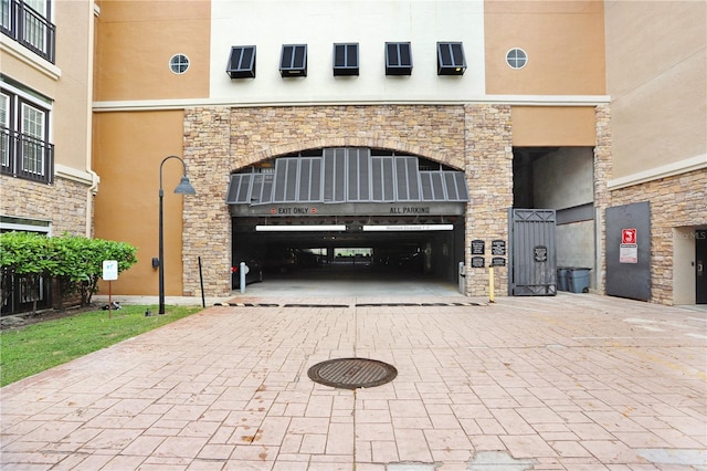 4221 W Spruce St Unit 1429, Tampa, FL 33607 - entrance to property featuring stone siding, stucco siding, and decorative driveway