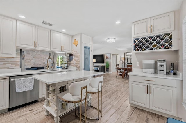 2824 Paddock Dr, Palm Harbor, FL 34684 - kitchen with dishwasher, backsplash, light countertops, light wood-style floors, and recessed lighting