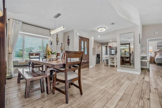 2824 Paddock Dr, Palm Harbor, FL 34684 - dining area featuring light wood finished floors and baseboards