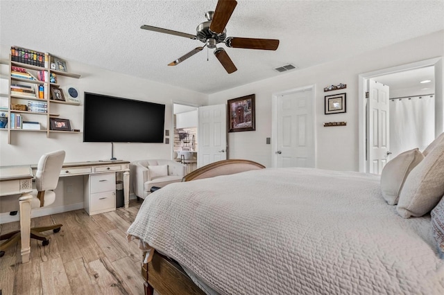 2824 Paddock Dr, Palm Harbor, FL 34684 - bedroom with light wood finished floors, a textured ceiling, a desk, a ceiling fan, and baseboards