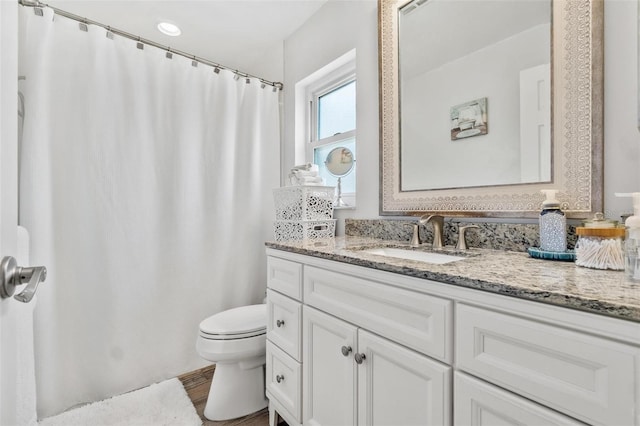 2824 Paddock Dr, Palm Harbor, FL 34684 - full bath with toilet, vanity, wood finished floors, and curtained shower