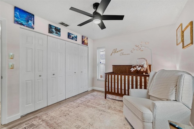 2824 Paddock Dr, Palm Harbor, FL 34684 - bedroom featuring wood finished floors, a closet, baseboards, and a ceiling fan