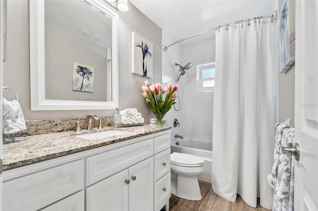 2824 Paddock Dr, Palm Harbor, FL 34684 - bathroom featuring vanity, shower / bathtub combination with curtain, toilet, and wood finished floors