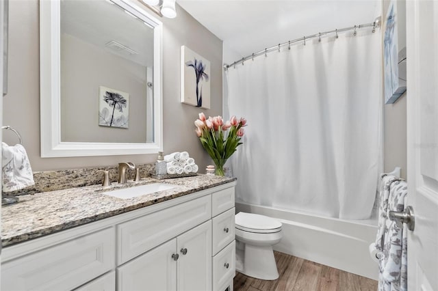 2824 Paddock Dr, Palm Harbor, FL 34684 - bathroom featuring vanity, toilet, shower / bath combo with shower curtain, and wood finished floors