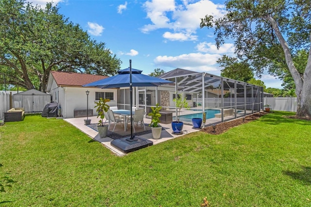 2824 Paddock Dr, Palm Harbor, FL 34684 - back of property with a patio area, stucco siding, a storage unit, and a lanai