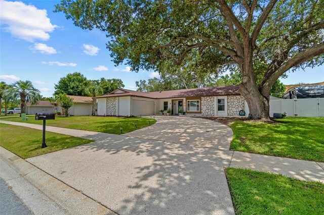 2824 Paddock Dr, Palm Harbor, FL 34684 - single story home with stone siding, a garage, and concrete driveway