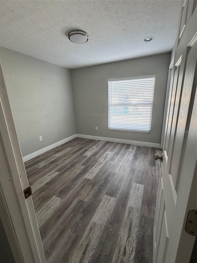 1215 Windsor Cir, Brandon, FL 33510 - unfurnished room with a textured ceiling, dark wood-type flooring, and baseboards